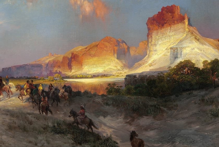 Riders cross a river below sunlit red cliffs on the open frontier